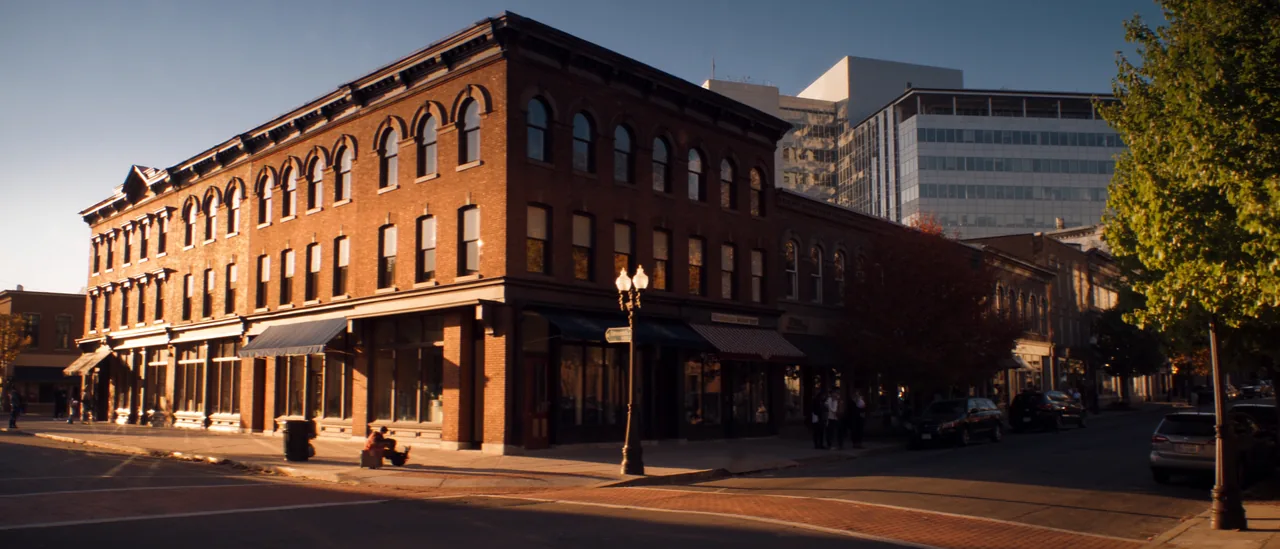 Brick commercial buildings along a New England downtown street at golden hour